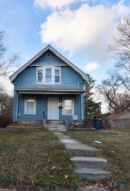 bungalow-style home featuring a front yard