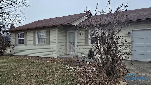 single story home featuring a garage and a front yard