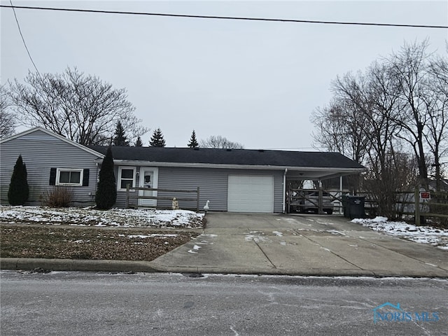 view of front of property with a garage and a carport