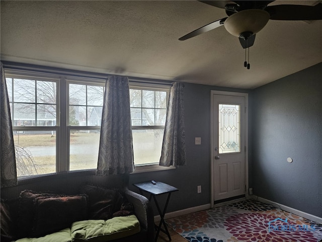 entryway featuring ceiling fan and a textured ceiling