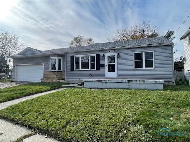 view of front facade with a front yard and a garage