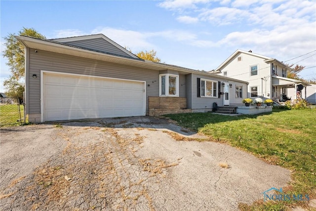 view of front of property with a garage and a front yard