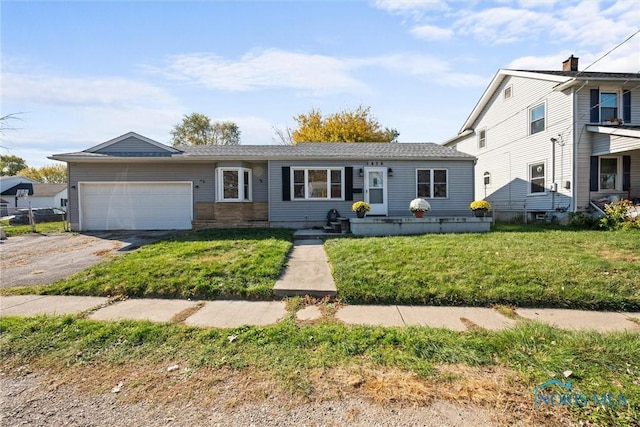 view of front of property featuring a garage and a front lawn