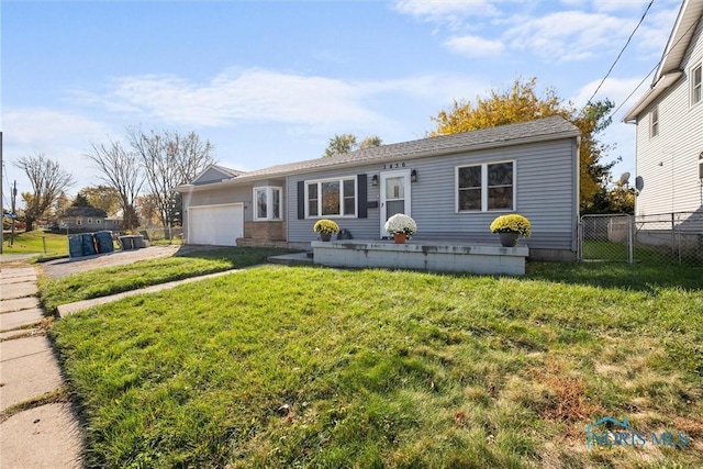 view of front of home featuring a garage and a front yard