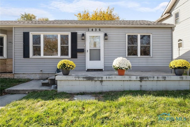 doorway to property with a yard