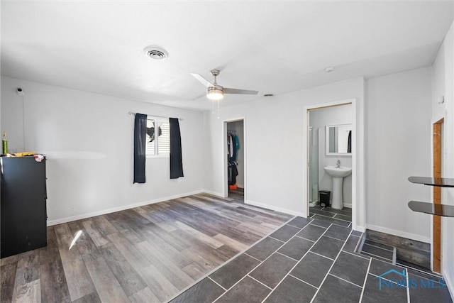 unfurnished room featuring sink and ceiling fan