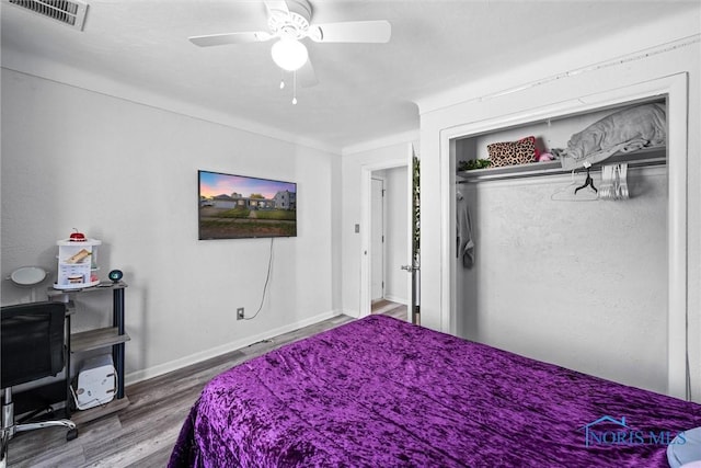 bedroom with wood-type flooring, a closet, and ceiling fan