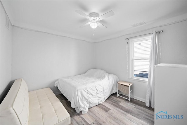 bedroom with ceiling fan and hardwood / wood-style floors