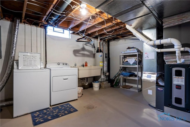 basement featuring sink, washing machine and clothes dryer, gas water heater, and heating unit