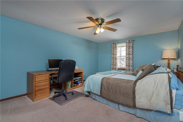 bedroom featuring ceiling fan, carpet flooring, and a textured ceiling