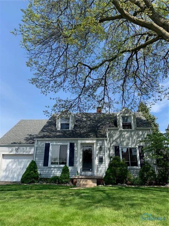 cape cod-style house featuring a garage and a front lawn