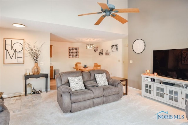 carpeted living room with ceiling fan