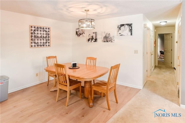 dining space with light hardwood / wood-style floors