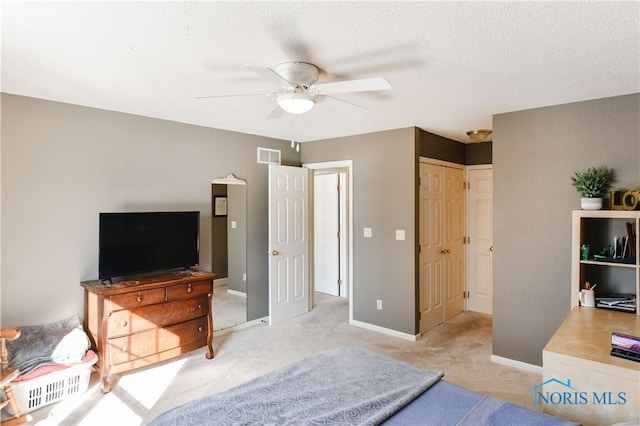 bedroom with light carpet, a closet, and ceiling fan