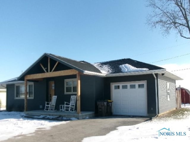 view of front of home with a porch and a garage