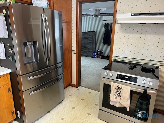 kitchen featuring appliances with stainless steel finishes and light colored carpet