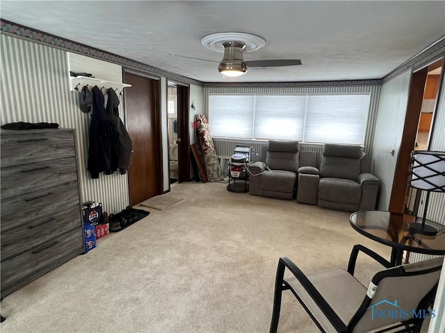 carpeted living room with ceiling fan