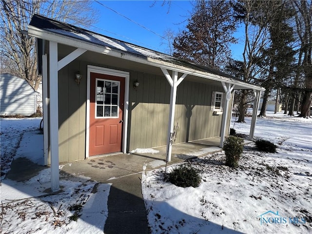 view of snow covered property entrance