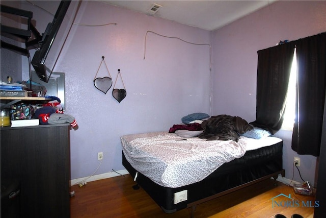 bedroom featuring wood-type flooring