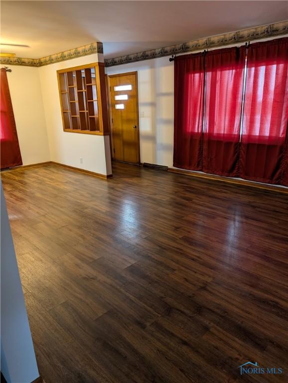 unfurnished room with dark hardwood / wood-style floors