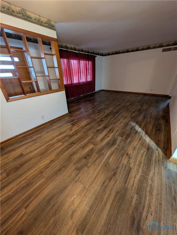 empty room with dark hardwood / wood-style floors