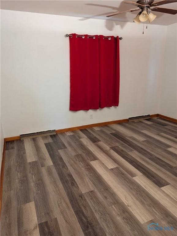 spare room with wood-type flooring and ceiling fan