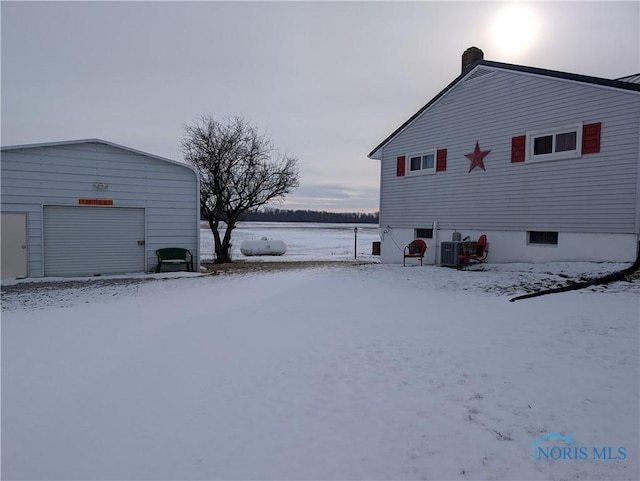 view of snow covered exterior featuring cooling unit