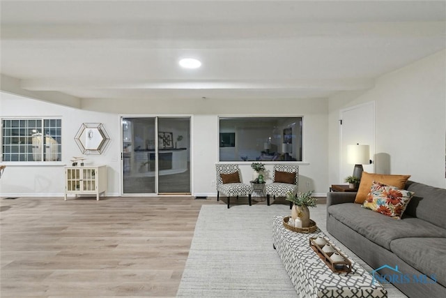 living room with beamed ceiling and hardwood / wood-style floors