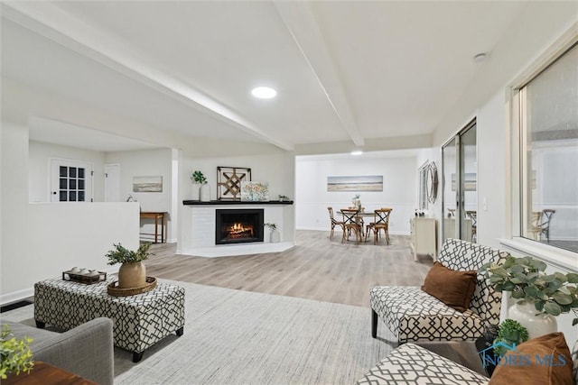 living room with beamed ceiling and hardwood / wood-style floors