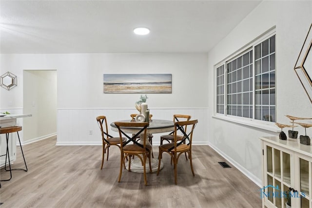 dining space with light hardwood / wood-style flooring