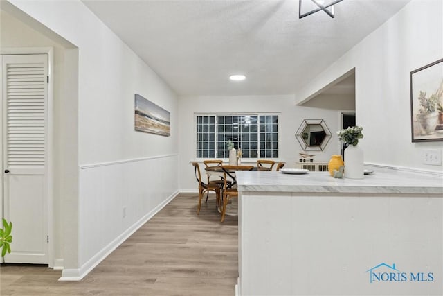 kitchen featuring hardwood / wood-style floors and a textured ceiling