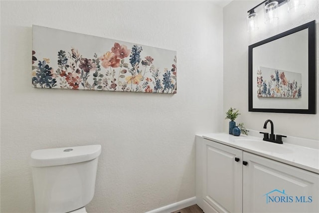 bathroom featuring vanity and toilet