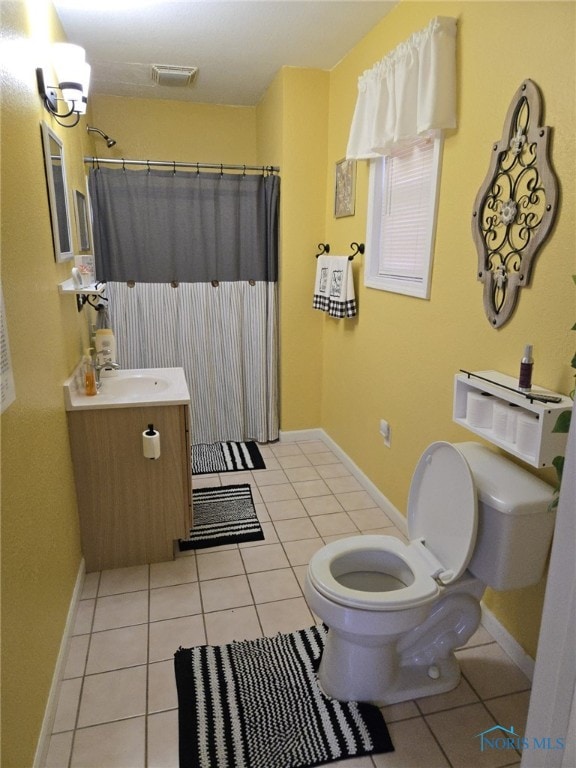 bathroom with vanity, walk in shower, tile patterned floors, and toilet