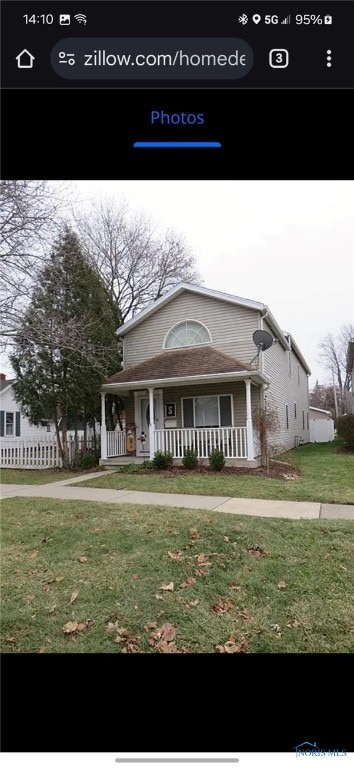 view of front of house with a front yard and covered porch