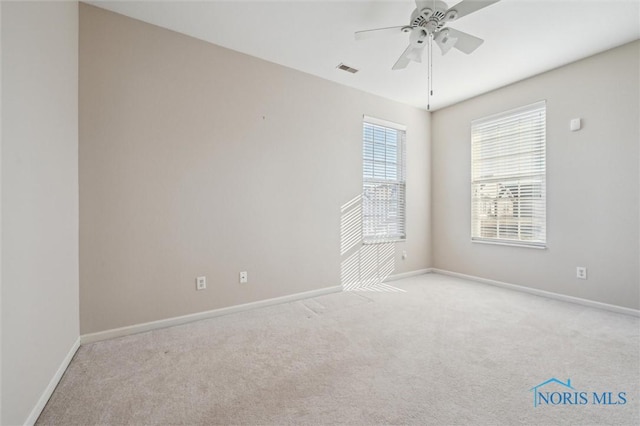 empty room with light colored carpet and ceiling fan