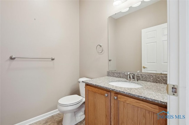 bathroom with vanity, tile patterned floors, and toilet