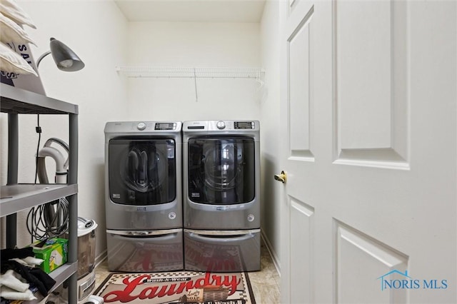 washroom with washing machine and clothes dryer