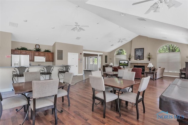 dining area featuring dark hardwood / wood-style flooring, lofted ceiling, and ceiling fan