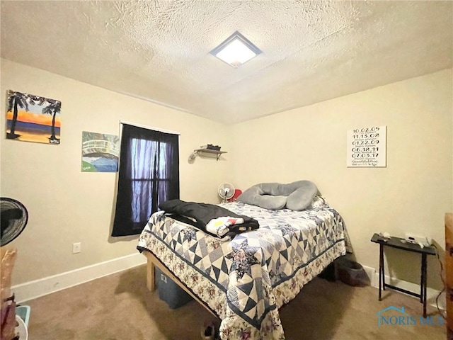 bedroom featuring carpet flooring and a textured ceiling