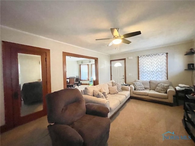 living room featuring carpet and ceiling fan