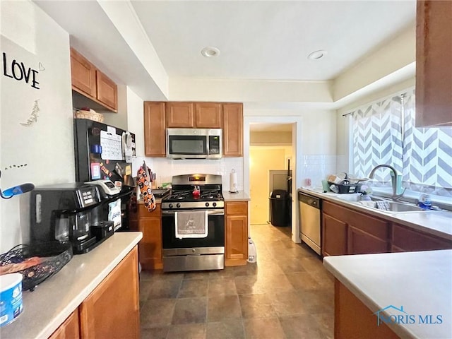 kitchen featuring appliances with stainless steel finishes, sink, and decorative backsplash