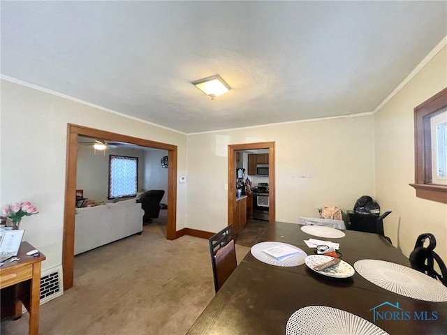 dining room with crown molding and a healthy amount of sunlight