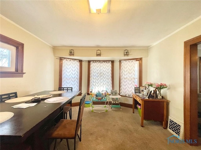 carpeted dining area featuring ornamental molding