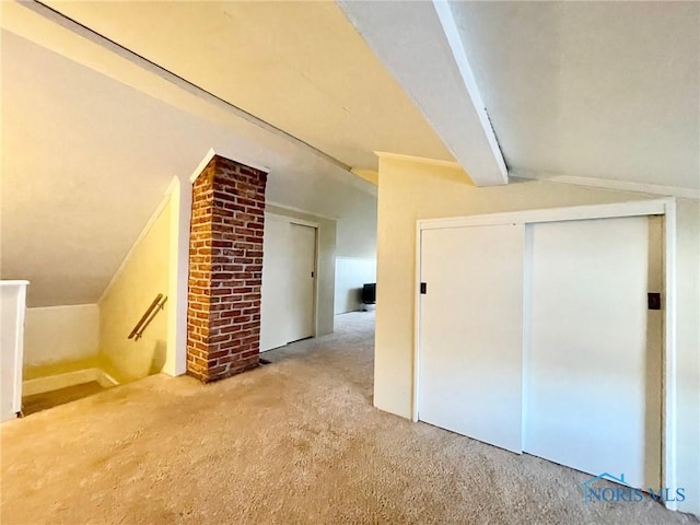 additional living space with carpet floors and vaulted ceiling