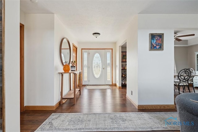 entryway with dark wood-type flooring and ceiling fan