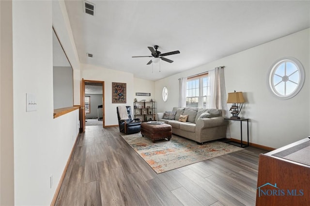 living room with hardwood / wood-style flooring, vaulted ceiling, and ceiling fan