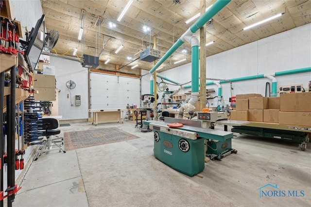 garage featuring a garage door opener and a workshop area