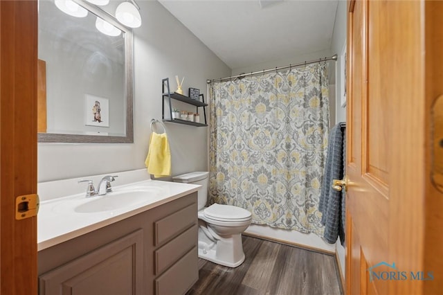 bathroom featuring hardwood / wood-style flooring, vanity, a shower with shower curtain, and toilet