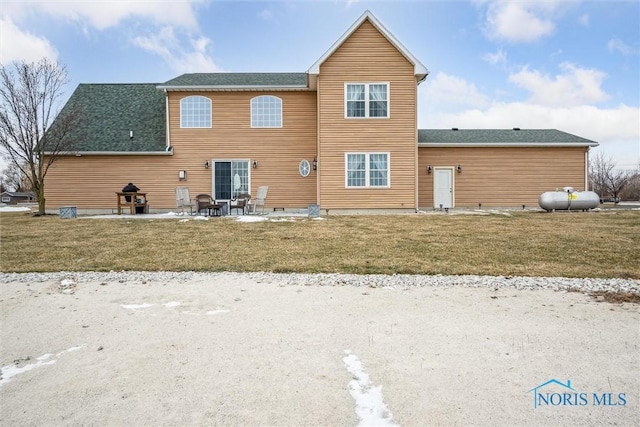 back of property featuring a yard and a patio area