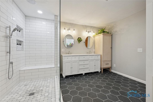 bathroom featuring vanity and tiled shower